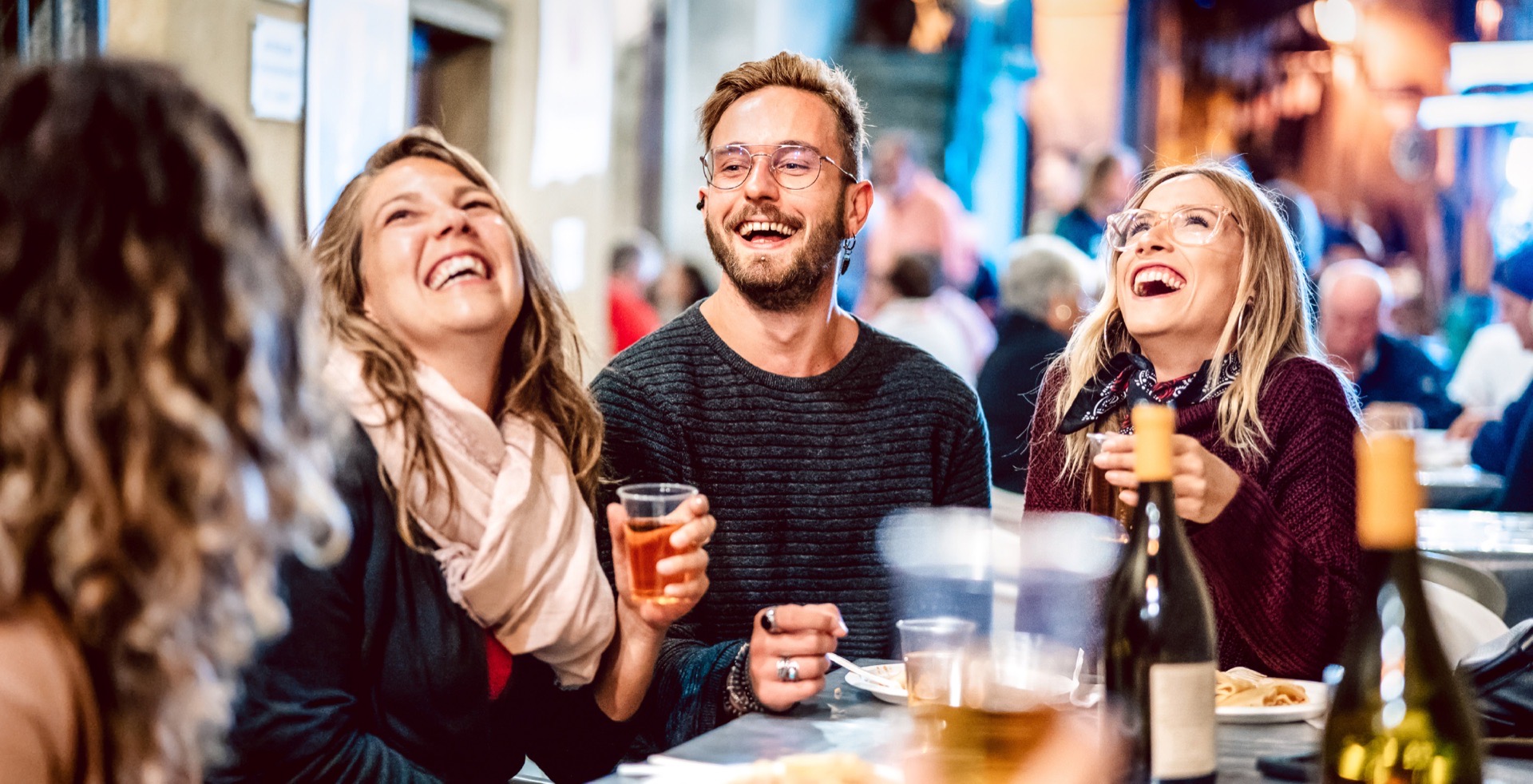 Friends laughing together in Salisbury City Centre cafe district
